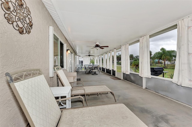 sunroom featuring ceiling fan and a wealth of natural light