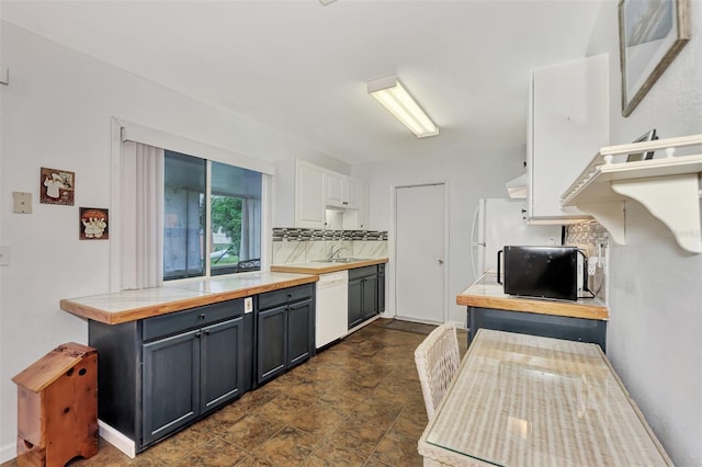 kitchen with sink, white cabinets, tasteful backsplash, butcher block countertops, and white appliances