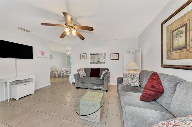 living room featuring ceiling fan and light tile patterned flooring