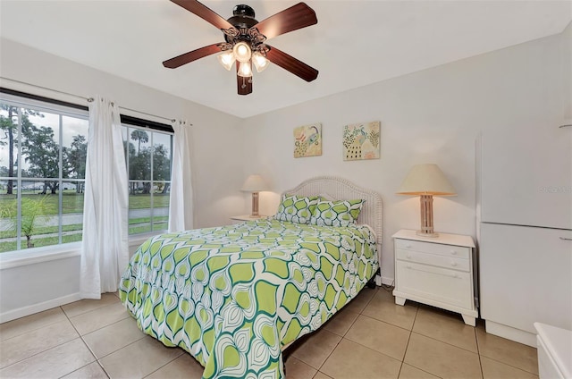 bedroom featuring multiple windows, tile patterned flooring, and ceiling fan