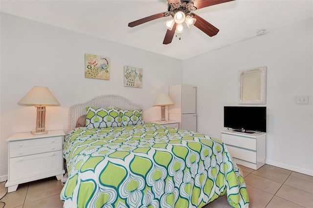 tiled bedroom featuring ceiling fan