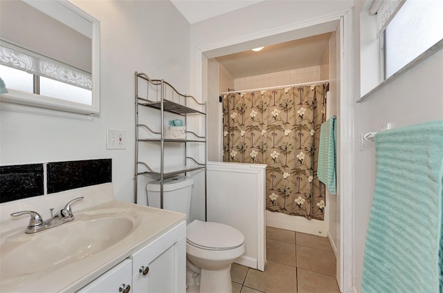 bathroom with vanity, toilet, and tile patterned flooring