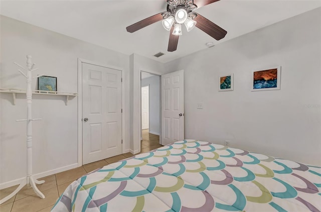 tiled bedroom with a closet and ceiling fan