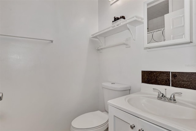 bathroom featuring curtained shower, toilet, and vanity