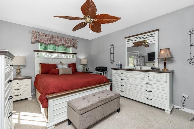 bedroom with light carpet, multiple windows, and ceiling fan