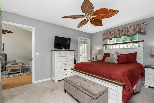 bedroom featuring ceiling fan and light carpet