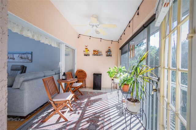 sunroom / solarium featuring ceiling fan