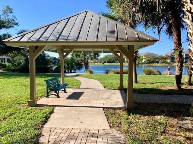 view of home's community with a gazebo, a yard, and a water view