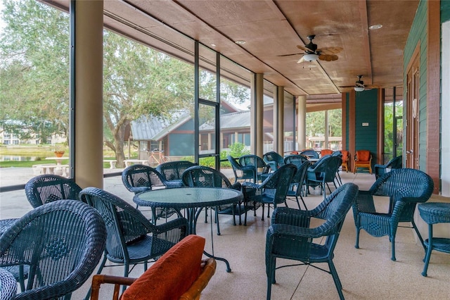 sunroom / solarium featuring ceiling fan