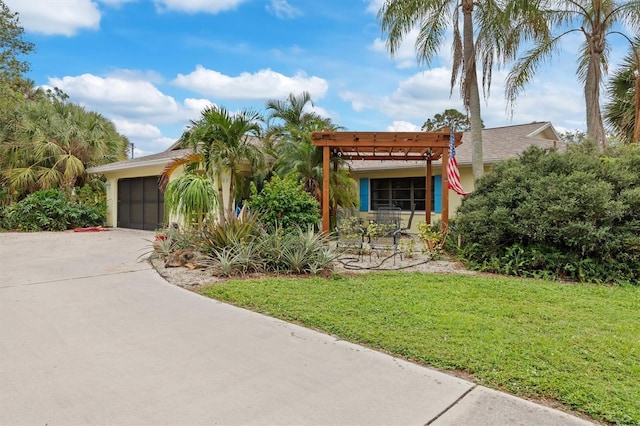 4290 Randypaar St, Port Charlotte, FL 33948 - view of front of house with a pergola, a front lawn, stucco siding, a garage, and driveway