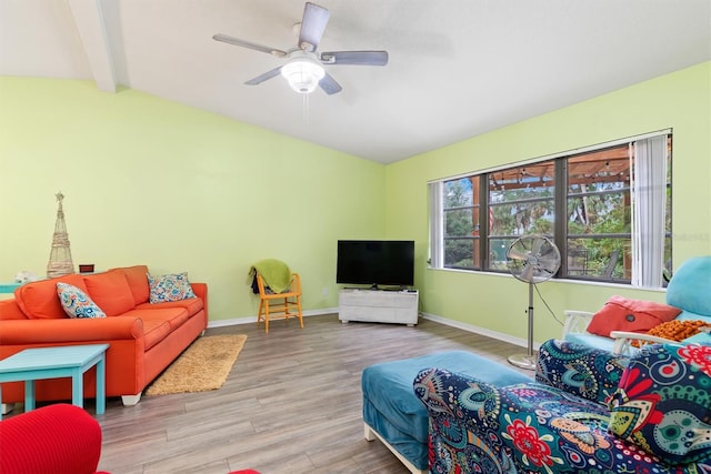 living room with vaulted ceiling with beams, light hardwood / wood-style floors, and ceiling fan