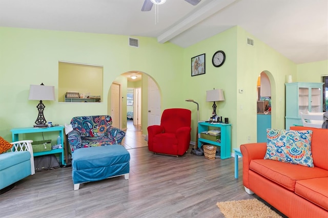 living room featuring ceiling fan, beam ceiling, and light hardwood / wood-style flooring