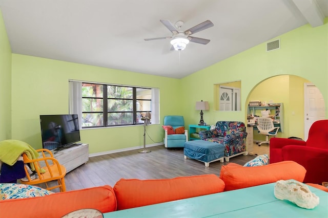 living room featuring hardwood / wood-style floors, vaulted ceiling with beams, and ceiling fan