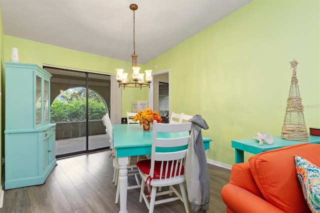 dining area with a notable chandelier and dark hardwood / wood-style floors