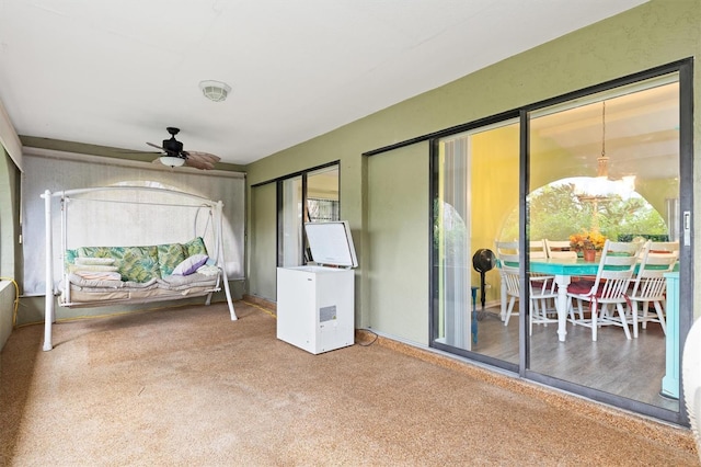 sunroom featuring a wealth of natural light and ceiling fan