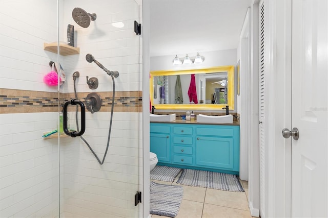 bathroom featuring toilet, vanity, tile patterned floors, and walk in shower