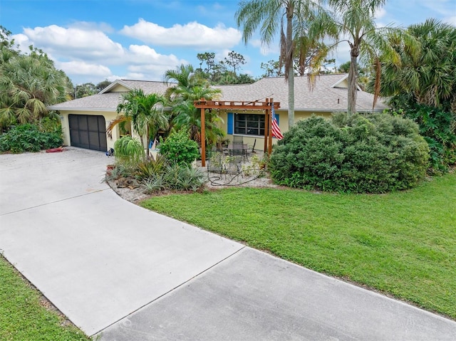 view of front of property featuring a garage and a front yard