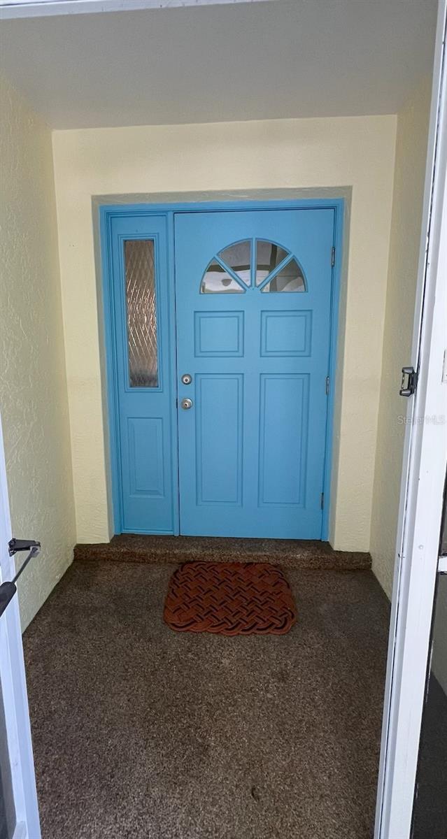 4290 Randypaar St, Port Charlotte, FL 33948 - doorway to property featuring stucco siding