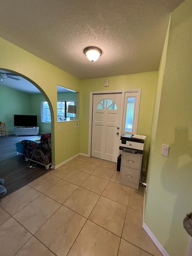 4290 Randypaar St, Port Charlotte, FL 33948 - entrance foyer featuring a textured ceiling, light tile patterned floors, and arched walkways