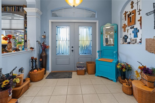 tiled foyer with french doors and ornate columns