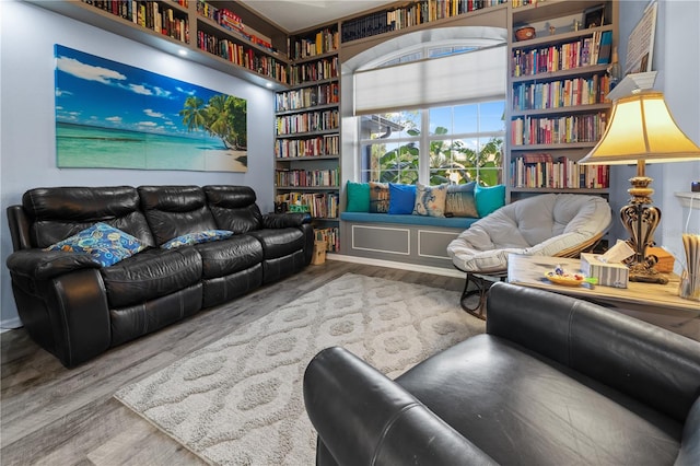 living room with hardwood / wood-style floors and built in shelves