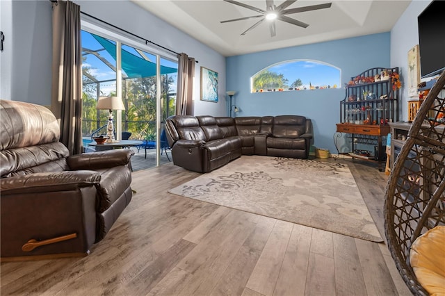 living room featuring ceiling fan and light hardwood / wood-style flooring