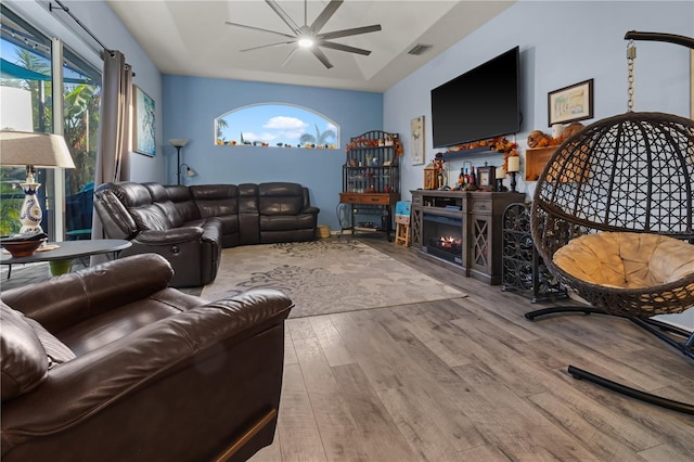 living room with ceiling fan and light hardwood / wood-style flooring