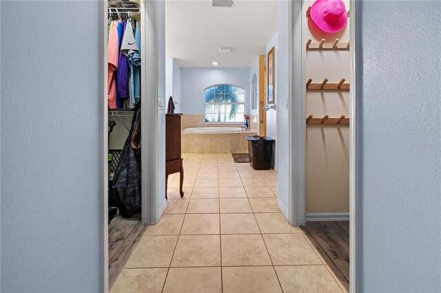 hallway featuring light tile patterned flooring