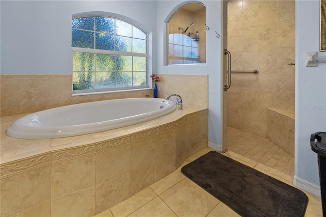 bathroom featuring tile patterned flooring and shower with separate bathtub