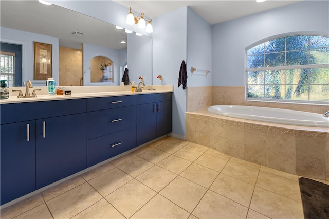 bathroom with vanity, tiled bath, and tile patterned floors