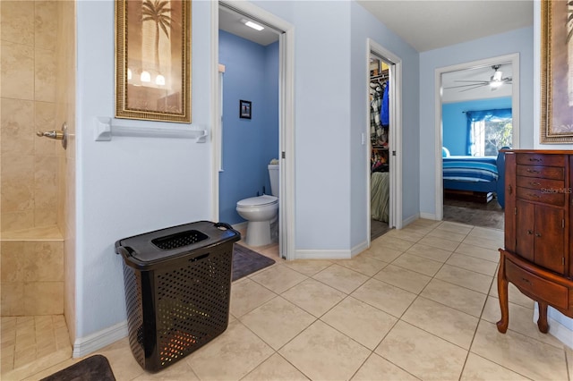 bathroom featuring tile patterned flooring, ceiling fan, toilet, and tiled shower