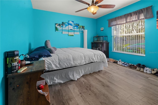 bedroom with ceiling fan and hardwood / wood-style floors