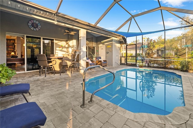 view of swimming pool with a patio, ceiling fan, and a lanai