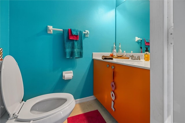 bathroom featuring tile patterned floors, vanity, and toilet