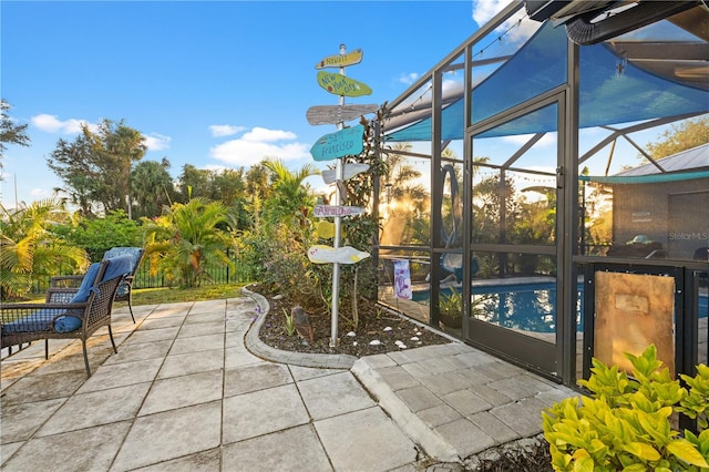 view of patio / terrace featuring glass enclosure