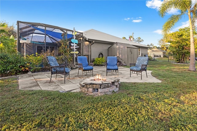 view of patio / terrace with glass enclosure and an outdoor fire pit