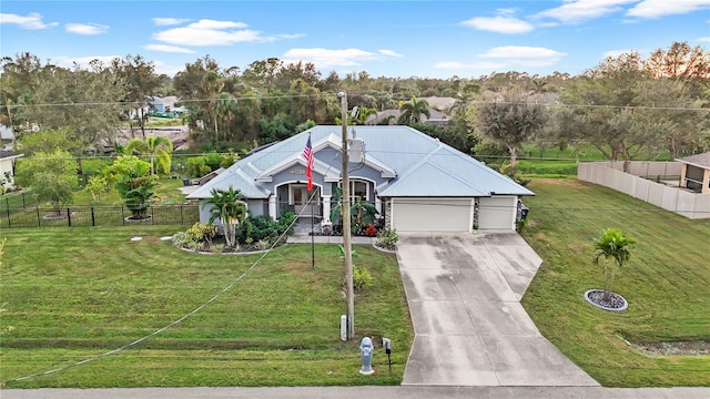 view of front of home featuring a front yard and a garage