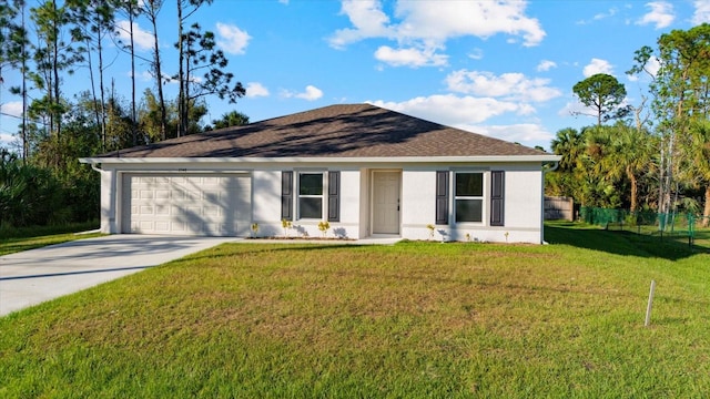 ranch-style house featuring a garage and a front lawn