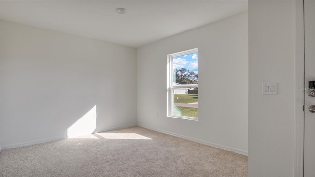 unfurnished room with light colored carpet