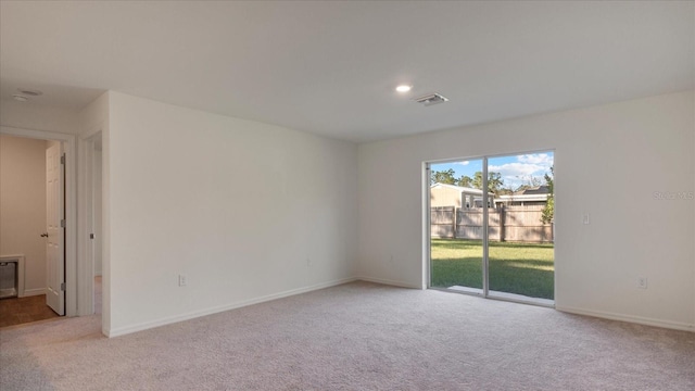 unfurnished room with light carpet