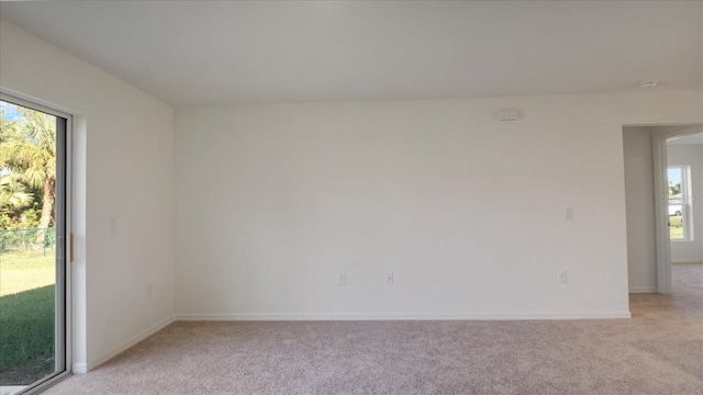 spare room featuring light colored carpet