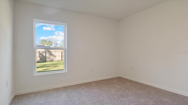 unfurnished room featuring light carpet