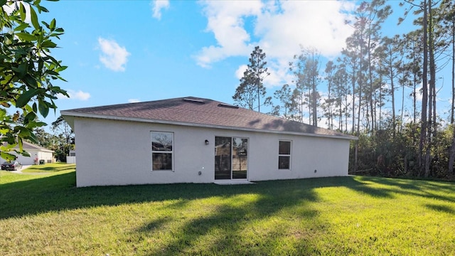 rear view of property with a lawn