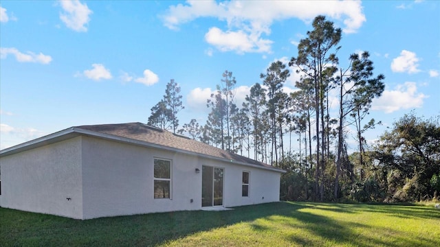 back of property featuring a lawn