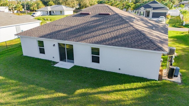 back of house featuring a yard