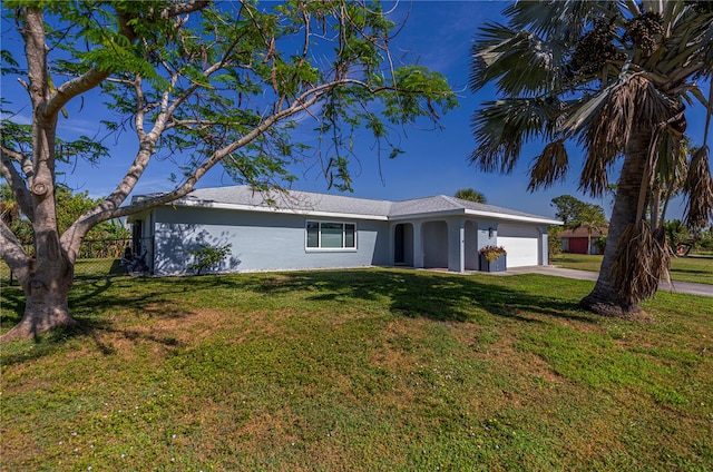 ranch-style home with a garage and a front yard