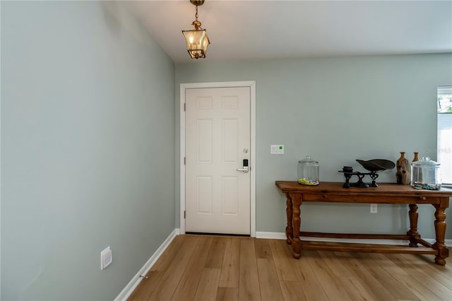 interior space featuring a notable chandelier and light wood-type flooring