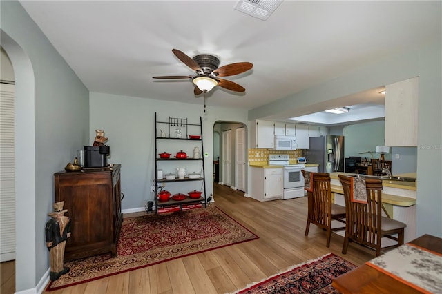 living room with ceiling fan and light hardwood / wood-style floors