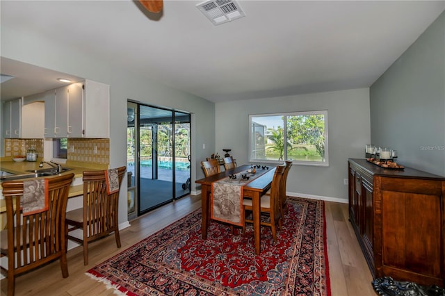 dining room featuring sink and light wood-type flooring