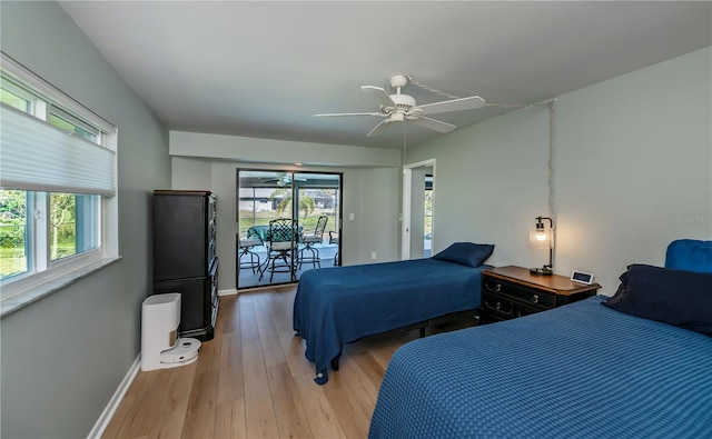 bedroom featuring hardwood / wood-style floors, ceiling fan, and access to exterior